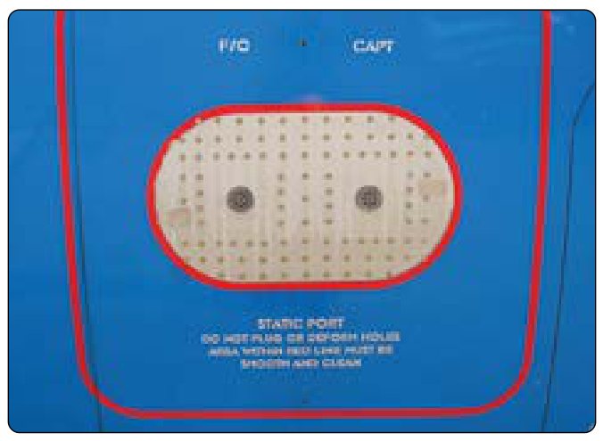 A blue fuselage panel with a red-outlined area holding two round static ports, labeled F/O and CAPT, among small holes, and a placard that says Static port, do not plug or deform holes.